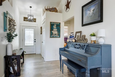 Entrance foyer featuring light wood finished floors and a chandelier