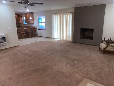 Open living room, wood burning stove, even a back 
