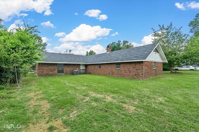 Back of house featuring central air condition unit