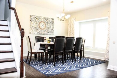 Formal Dining Room with Custom Chandelier and Recessed Lighting