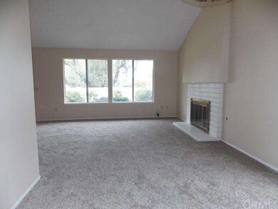 Bright living room with vaulted ceilings and firep