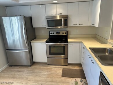 Kitchen with sink, stainless steel appliances, whi