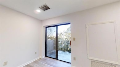Unfurnished room with baseboards, visible vents, a
