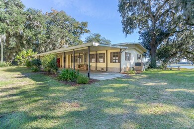 Large covered carport attached to the house with a