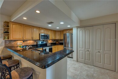 Updated kitchen has snack bar with granite counter