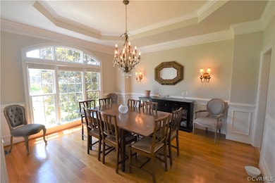 Beautiful Dining Room with tray ceiling, arched wi
