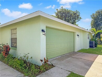 Garage with concrete driveway and central AC unit