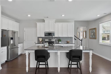 Beautiful kitchen with center island, walk in pantry and ss appliances.
