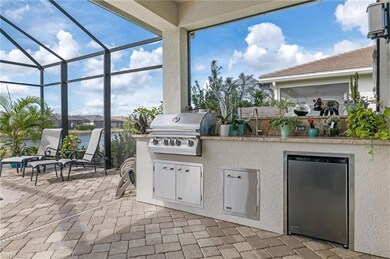 Outdoor kitchen features a Lyon BBQ, a stainless steel sink and a fridge!