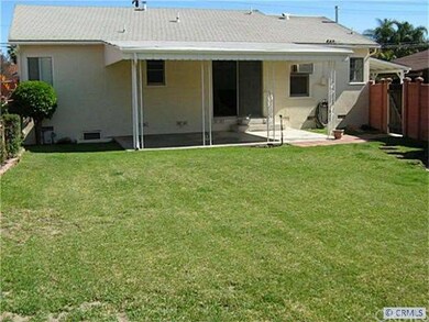 View of rear of home, fully fenced, covered patio