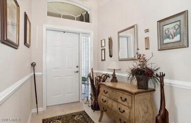 Foyer entrance featuring light tile patterned floo