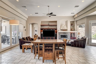 Dining space featuring ceiling fan, a fireplace, a