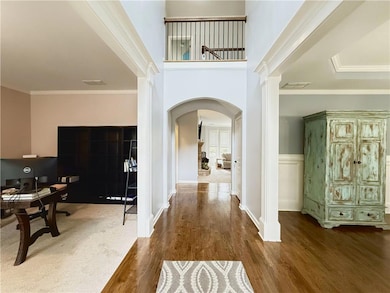 Two story foyer entry with large windows which cre
