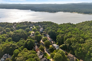 Aerial perspective of suburban area with a forest and a water and mountain view