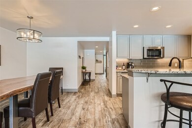 Kitchen with pendant lighting, sink, light stone c