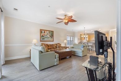 Living room featuring ceiling fan with notable cha