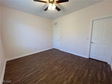 Spare room featuring dark wood-type flooring, a ce
