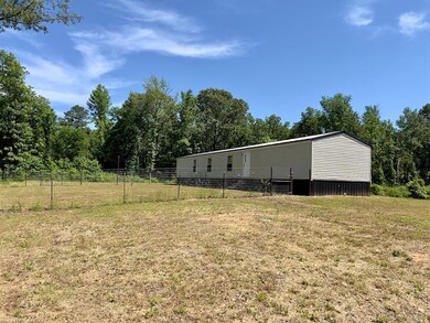 View of yard featuring a pole building and fence