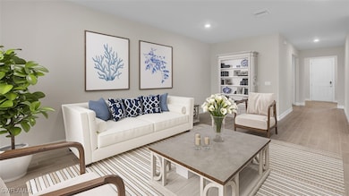 Living room with light wood-style flooring and rec