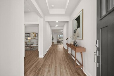 Foyer entrance with wood finished floors and baseboards