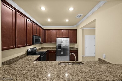 Kitchen with sink, ornamental molding, light tile