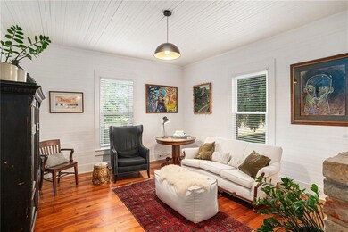 Living room with hardwood / wood-style flooring and baseboards
