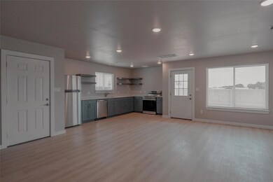 Kitchen with stainless steel appliances, open she