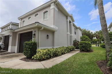 View of side of property with stucco siding, a garage, concrete driveway, and a yard