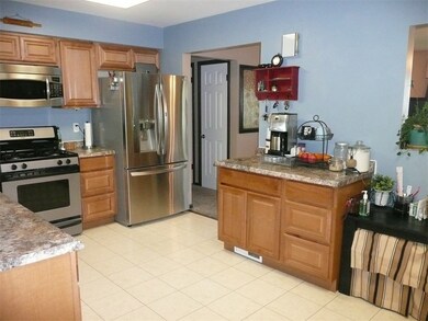 Kitchen with updated counter tops and coffee/breakfast bar.