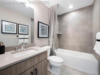 Bathroom with bathtub / shower combination, vanity, and light tile patterned floors