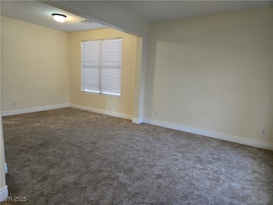 Unfurnished room featuring carpet floors and baseboards