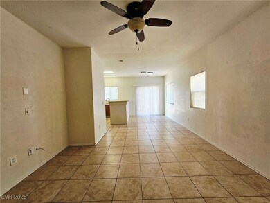 Spare room featuring ceiling fan, light tile patte