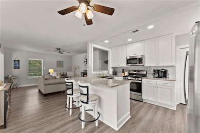 Kitchen featuring stainless steel appliances, whit