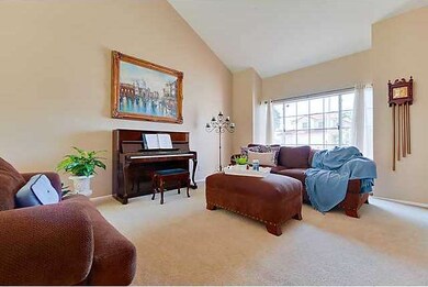 An inviting living room welcomes you with high cei