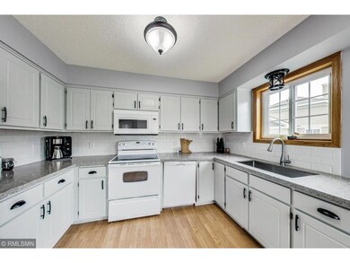 The kitchen features quartz counter tops, white su
