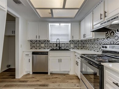 Kitchen with stainless steel appliances, visible v