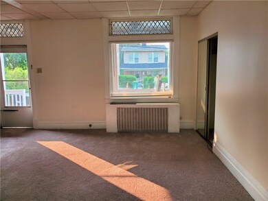 Living room has a large window that over looks the front porch, and lets in lots of sun light.