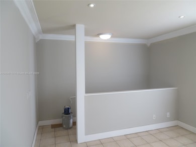 Living room from entry stairway.  The apartment has been freshly painted in light gray with white trim