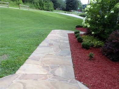 Stone sidewalk with beautiful landscaping.