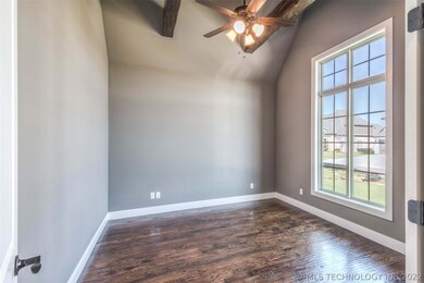 High ceilings, beams and a large window provide an