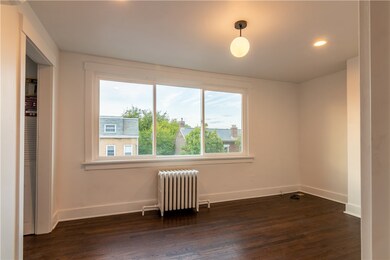 Bedroom 1 with large windows and a simple light fi