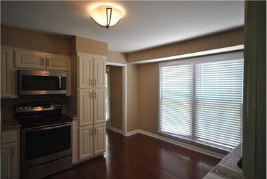 Another view of the kitchen facing the large bay windows that overlook the patio and backyard. The kitchen also accesses a walk-in utility room and garage/study area, in addition to the den and dining room.