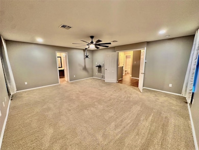 Unfurnished bedroom featuring light colored carpe