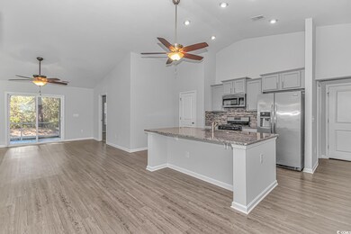 Kitchen featuring gray cabinetry, ceiling fan, an 