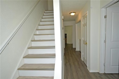 Stairway featuring baseboards and wood finished fl