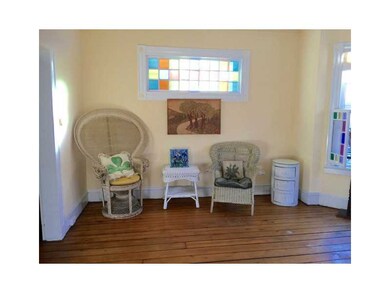 Living Room. NB: STAIN GLASS AND WOOD FLOORS