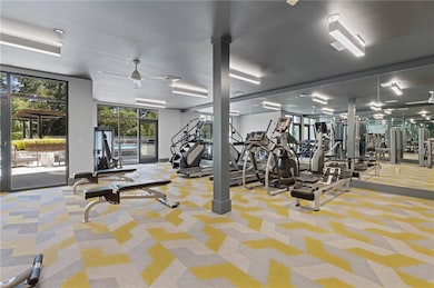 Gym featuring a ceiling fan and carpet