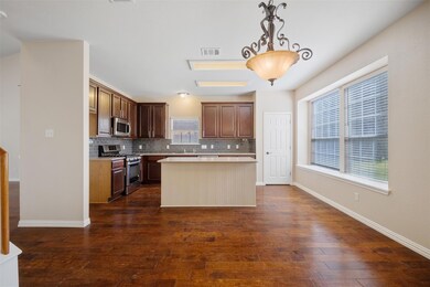 Kitchen featuring visible vents, backsplash, stai