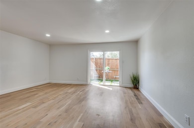 Ample light floods the open living and dining spac