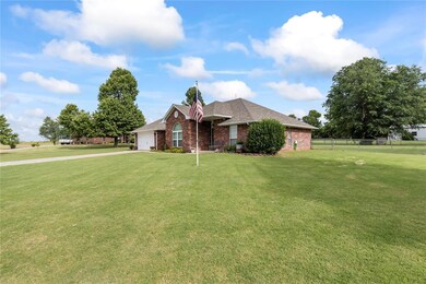 Ranch-style home featuring a garage and a front ya
